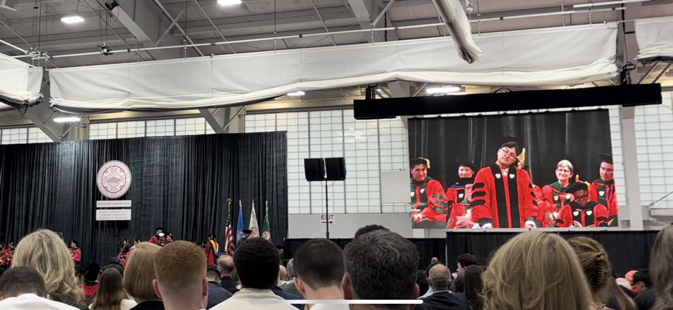 Eddie being hooded by Ruben at graduation